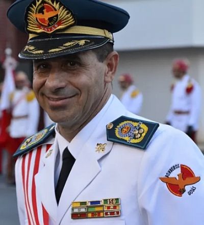 Colonel in the role of Commander In Chief wearing a white dress