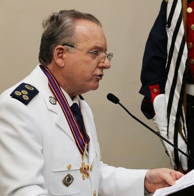Colonel in the role of a Military Court Judge wearing a white great gala dress